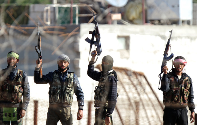 Syrian opposition fighters celebrating on the strategic Syrian border town of Ras al-Ain, on November 15, 2012 (AFP Photo / Bulent Kilic)